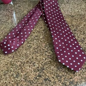 Mort Wallin tie. Maroon with white polka dots. 100% Swiss polyester. 3 1/4”